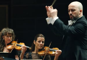 A serious man conducting. From the concert. 