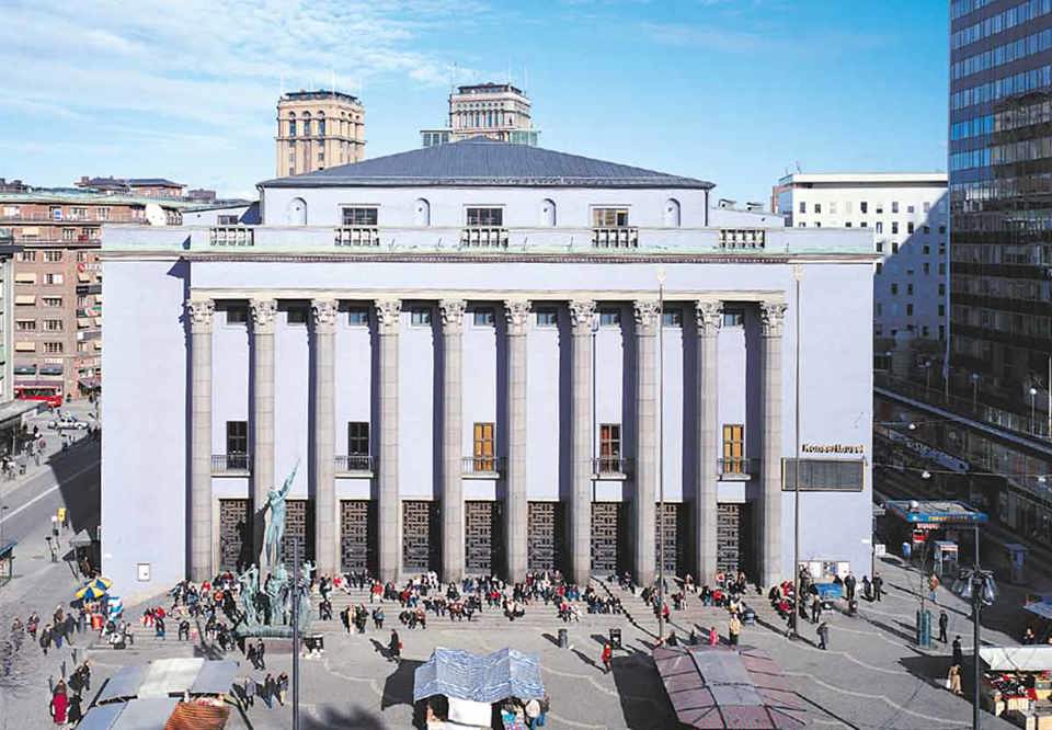 Bild på det blåa konserthuset. Stora pelare ramar in byggnaden. Fotografi