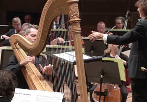 Mann playing harp. From the concert.