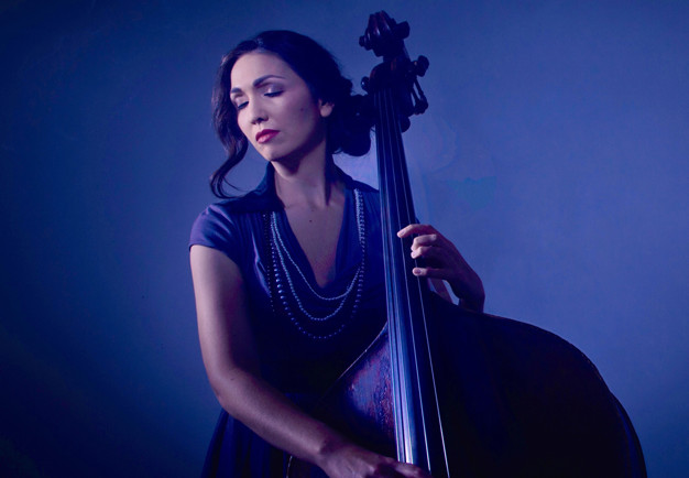 Woman with double bass. Blue-toned photography.