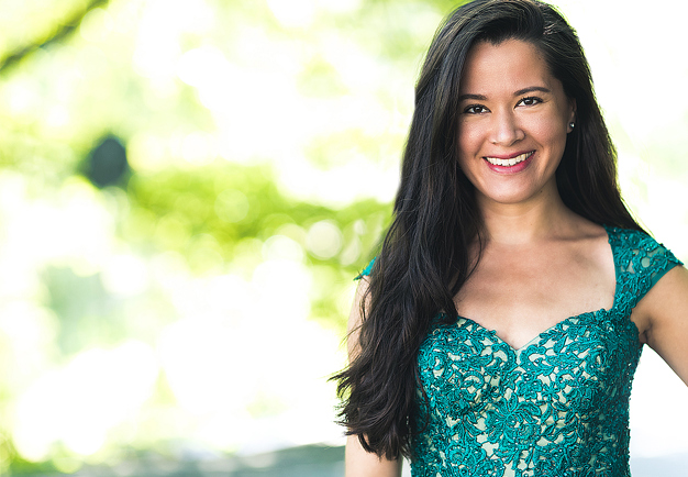 Woman with dark hair and a green dress. Photo.