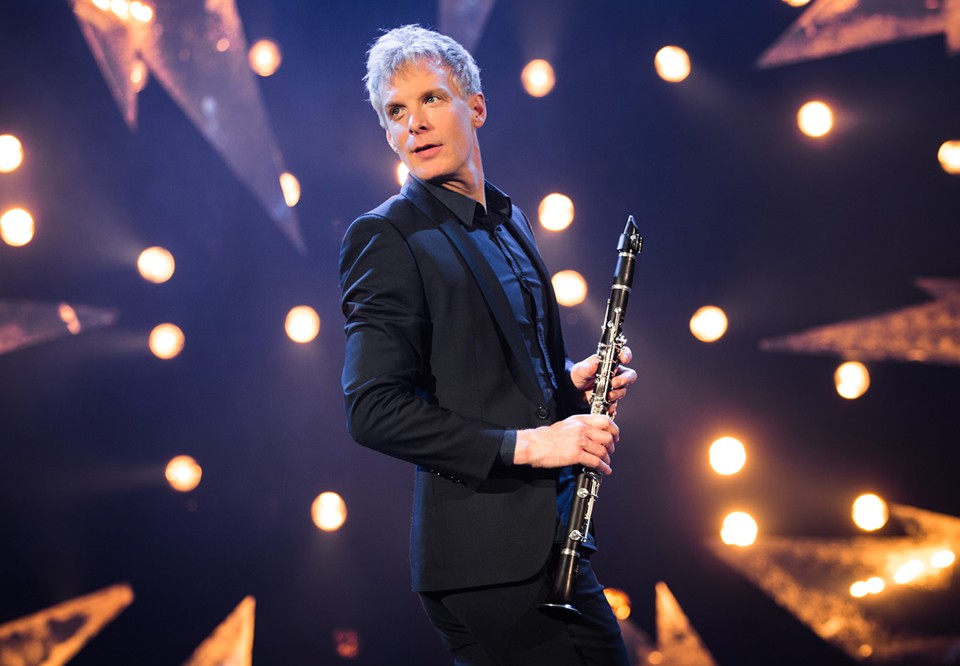 Portrait of a man with a clarinett in his hand. Photo.