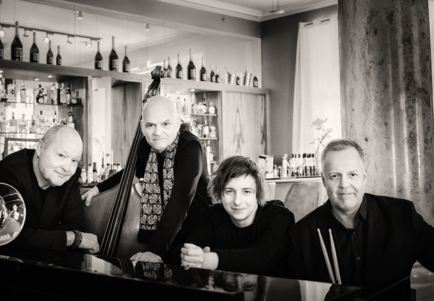 Four men standing in line. Photo.