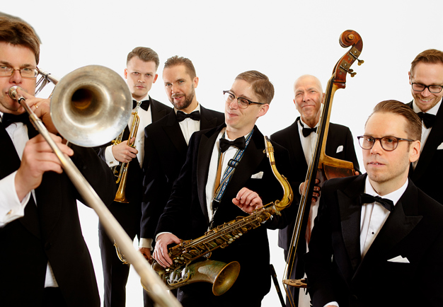 Sju jazzmusiker med sina instrument. Foto