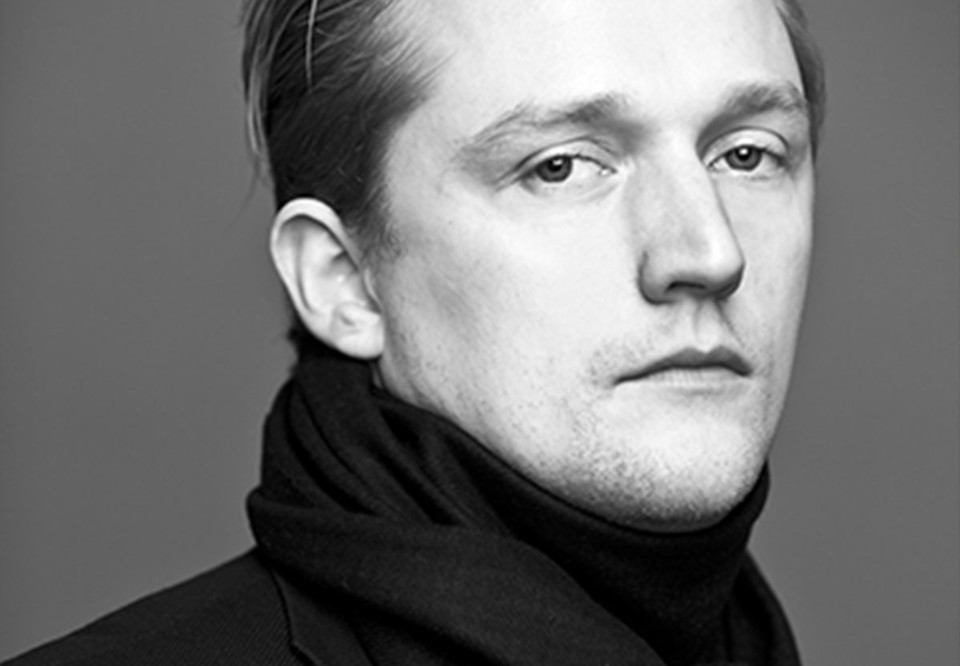Portrait of a man in dark clothes. Photo.