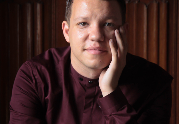 Close up of man leaning his chin in his hand. Photography.