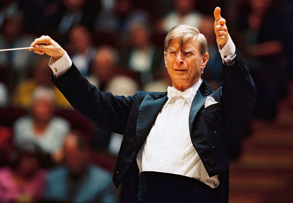 Elderly man conducting. Hands in the air. Photography.