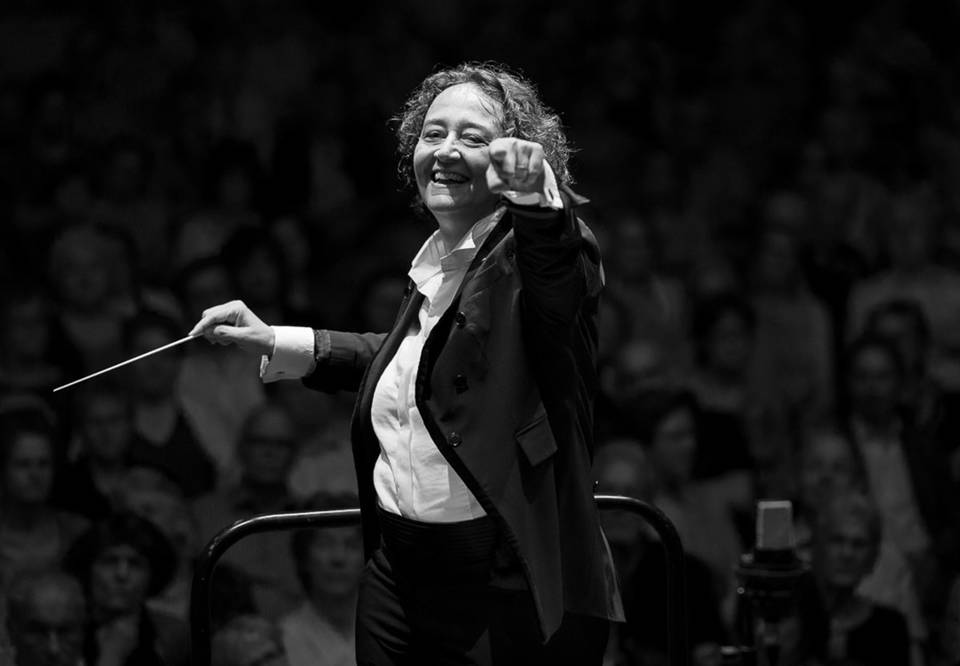 A black and white picture of a woman conductor.
