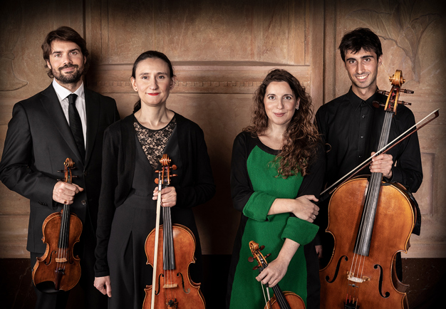 Four musicians in a row with instruments. Photo.