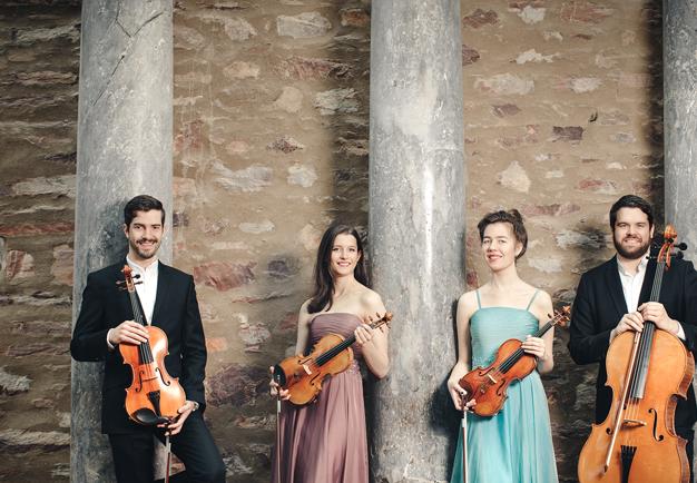 Young people holding instruments. Photo.