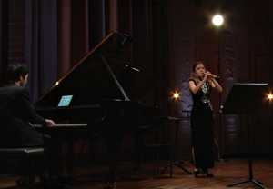 Woman playing oboe. Photo.