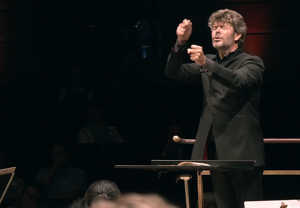 Man conducting with intense. From the concert.