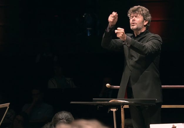 Man conducting with intense. From the concert.