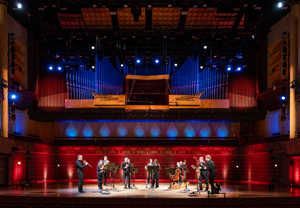 Musicians standing with their instruments. From the concert.