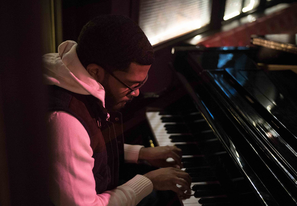 Man som spelar piano. Fotografi.