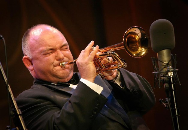 Photo of a man playing a trumpet.