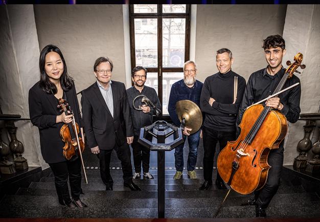 Musicians standing on stairs. Photo.