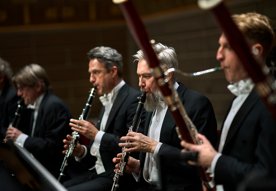 Four men playing their instruments.  Photo. 