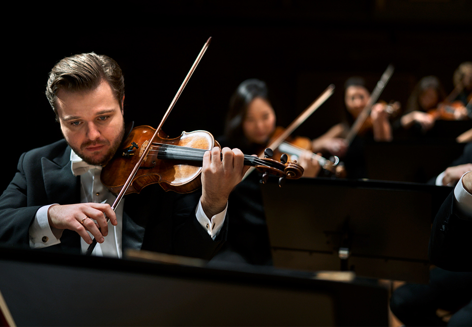 Photo of a man playing the violin. 