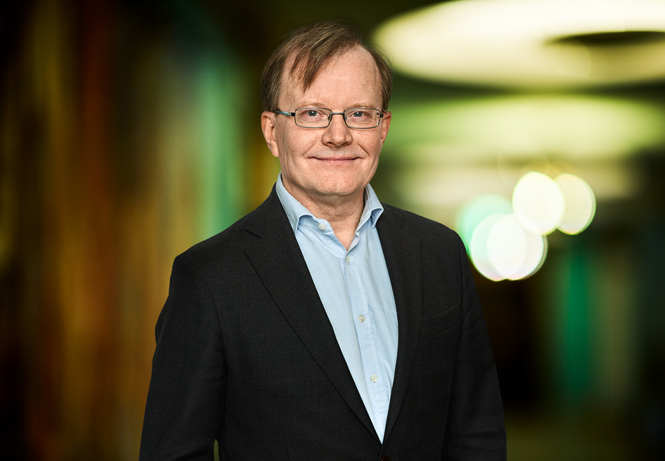 Man with glasses smiling into the camera. Photo.