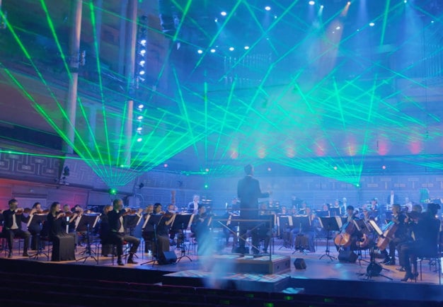 Green lights on a stage with musicans.