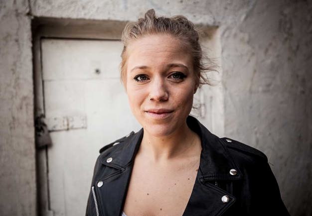 Close up of a young female in a leather jacket. Photo.