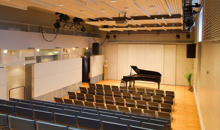 Piano standing on stage. Photo.