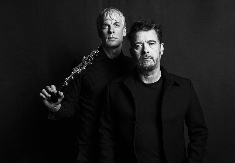 Men with dark clothes. Photo.