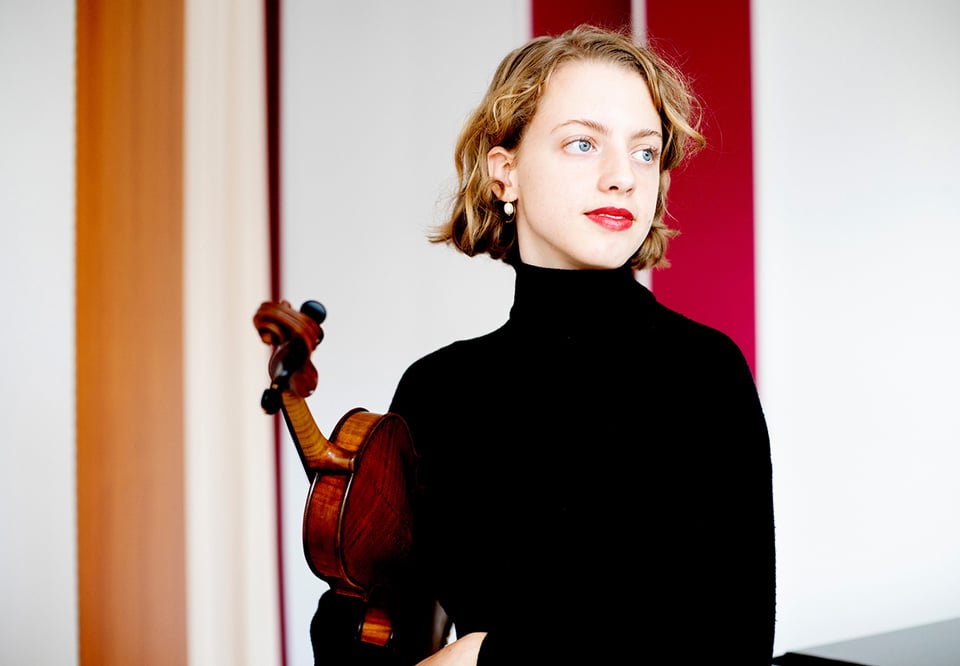 Woman holding a violin. Photo