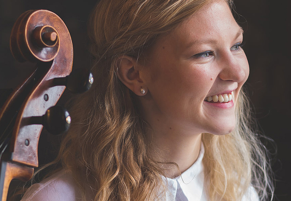 Young girl with a cello leaning against her shoulder. Photo