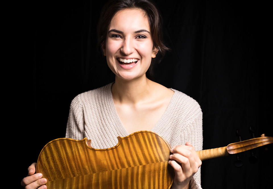 Woman holding a violin. Photo.