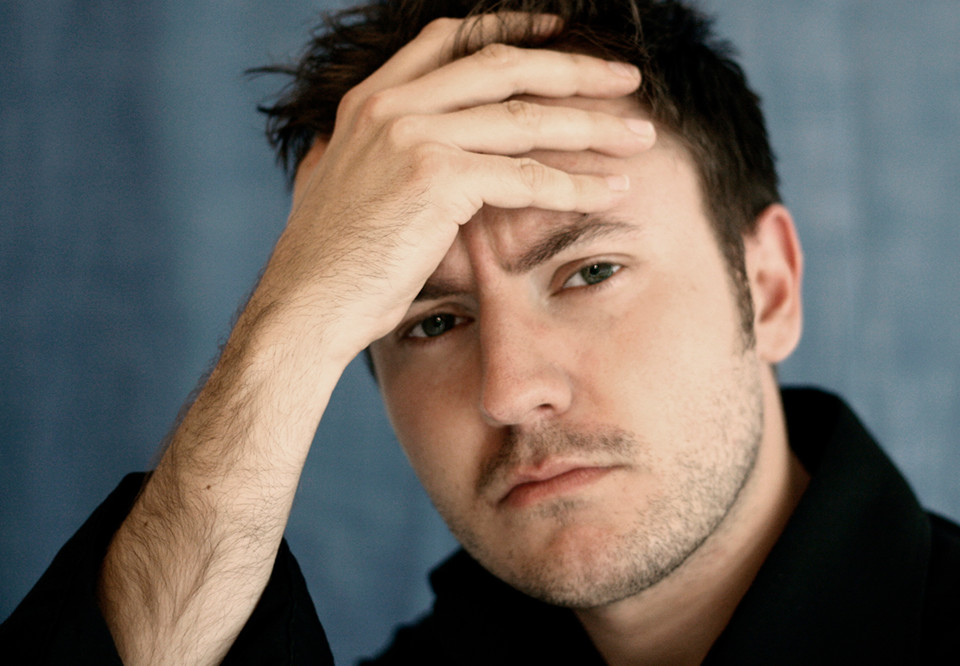 Man looking into the camera. Photo.