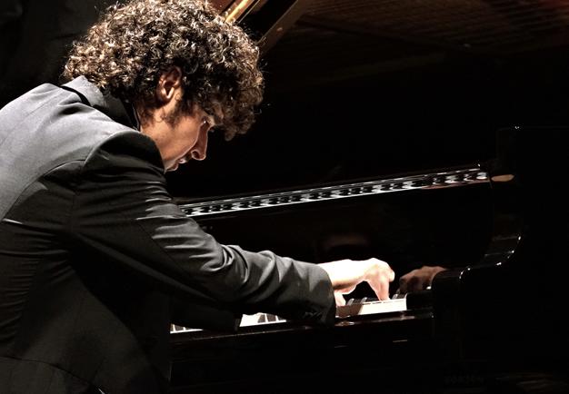 Photo of a man playing the piano.