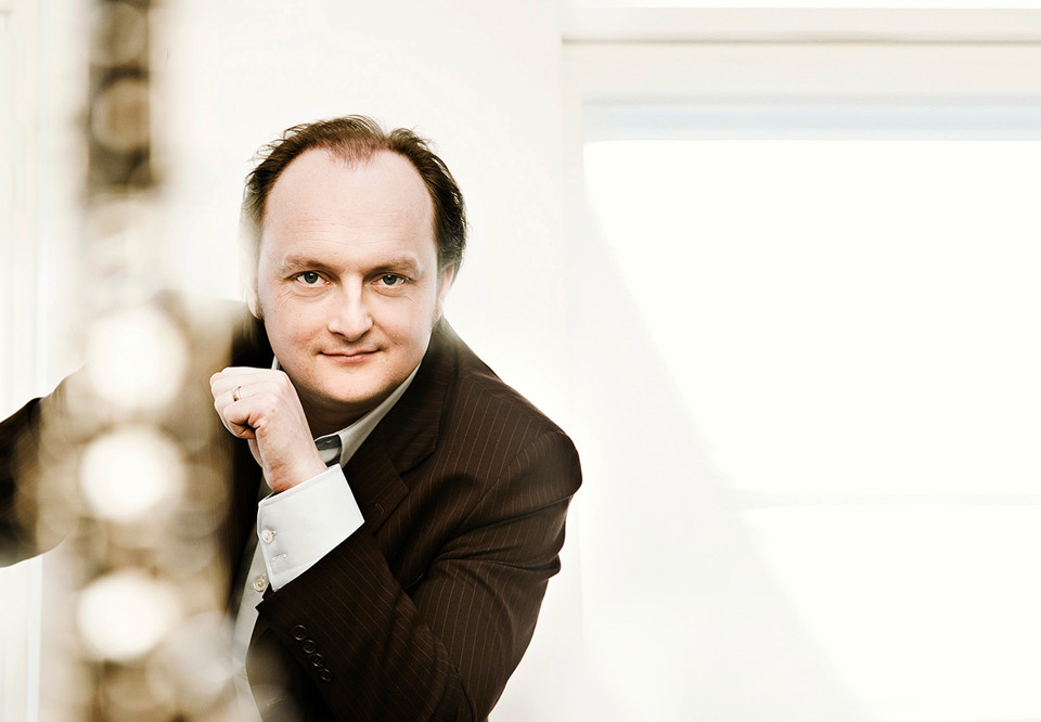 Man med oboe framför sig. Fotografi.