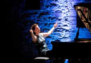 Woman playing the piano. Photo.