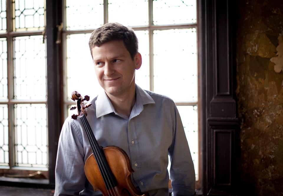 Man sitting with a violin. Photo