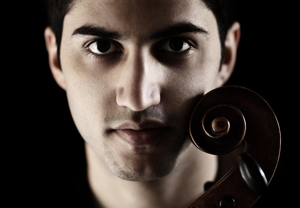Young guy with his cello. Photo.