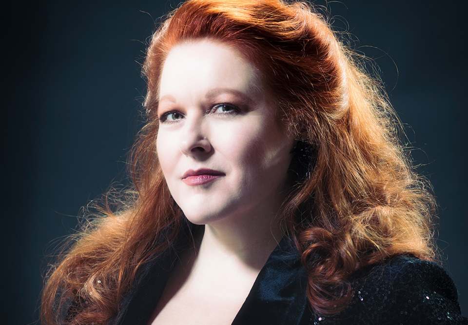 Close up on a woman with red hair. Photo.