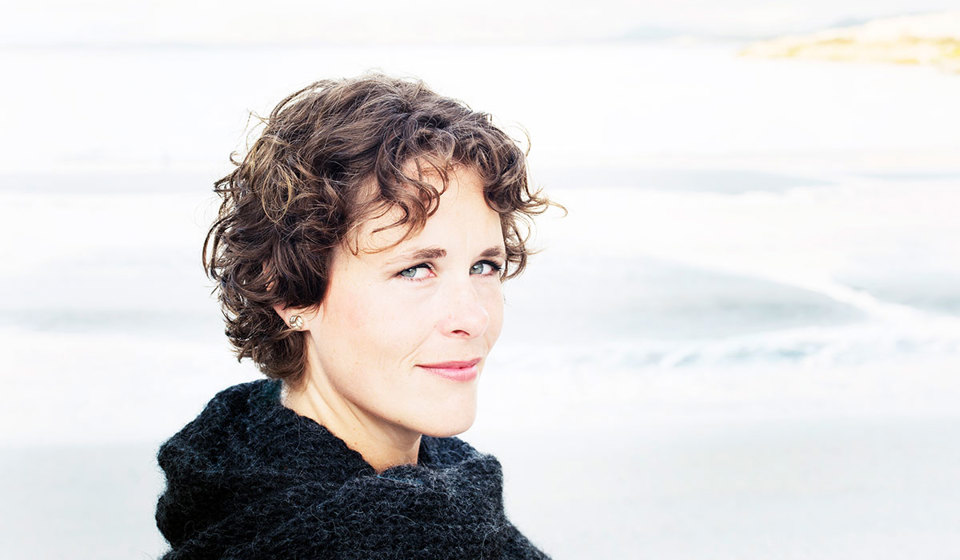 Close up picture of a woman in short brown hair.