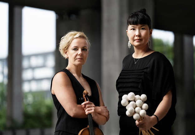 Two musicians holding there instrument. Photo.