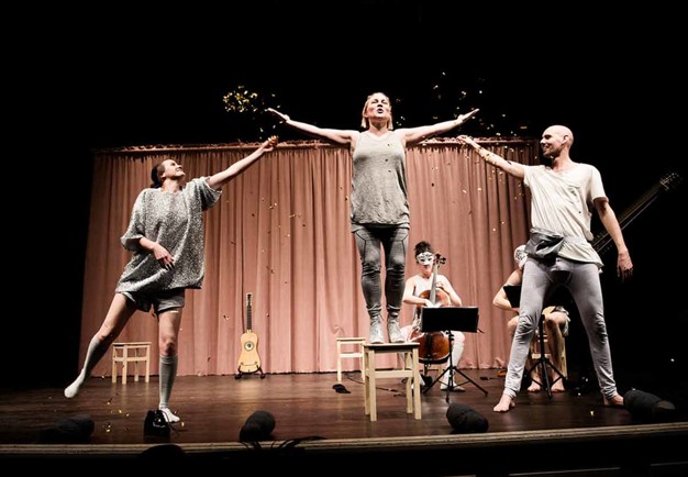 Group picture of Operabyrån, three persons standingon a stage. Photography.