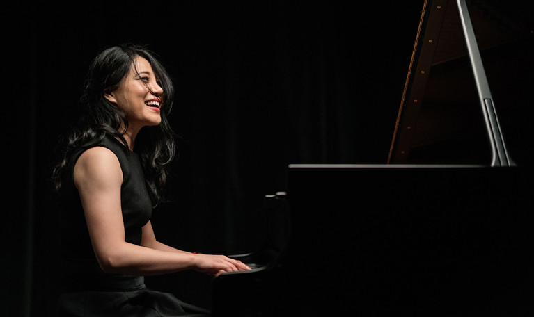 Kvinna som spelar piano. Fotografi.