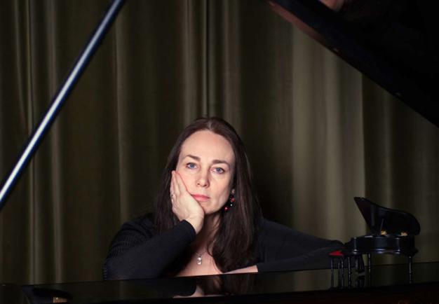Woman sitting by the piano. Photo