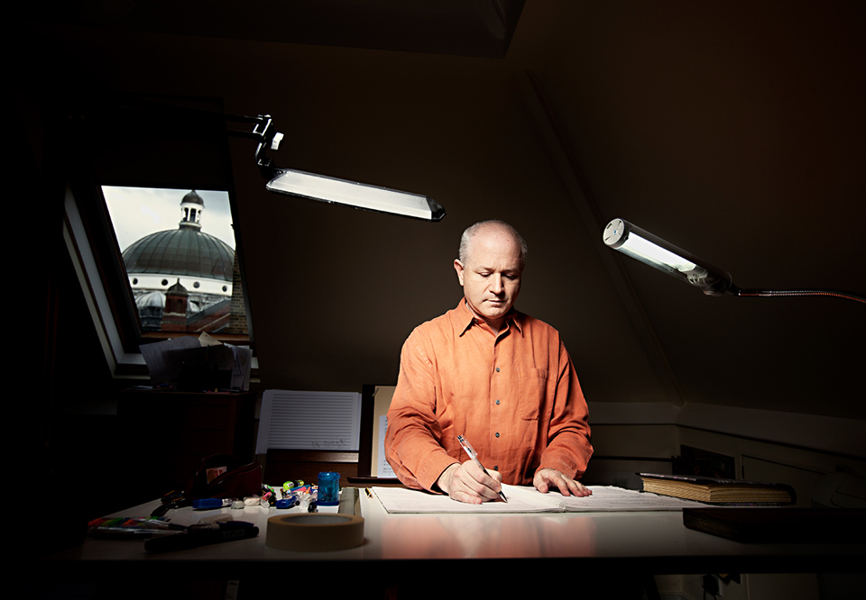 Man behind a desk with notes in front of her. Photography